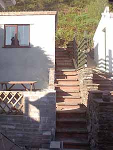 The back garden, with patio and storage building
