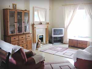 Living Room, with large window, sofas, rugs and television