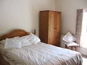 Upstairs Master Bedroom, with wardrobe, bed, chair and window